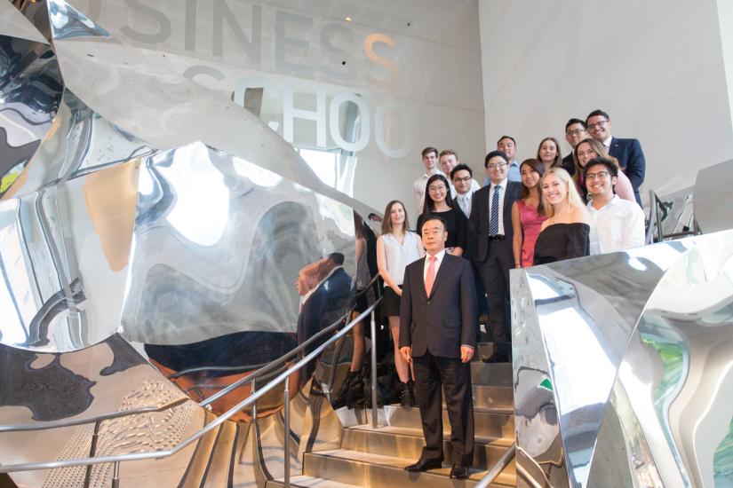 Dr Chau Chak Wing standing with scholars on stairs in Building 8