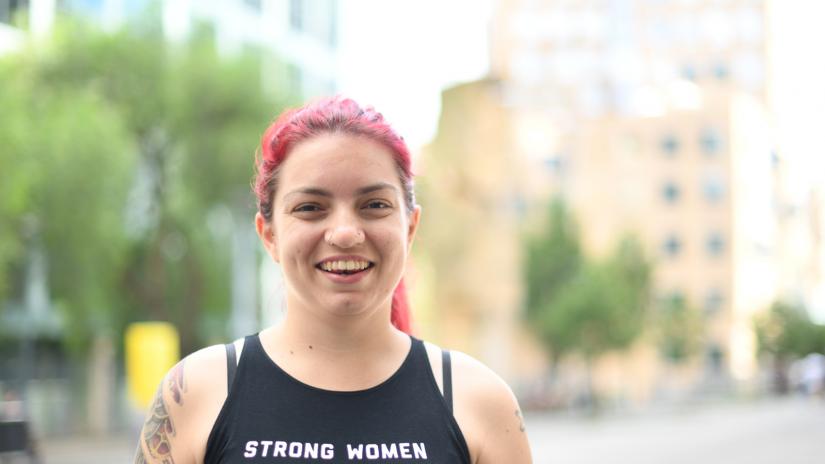 Brooke Ottley smiling at the camera with Building 8 in background