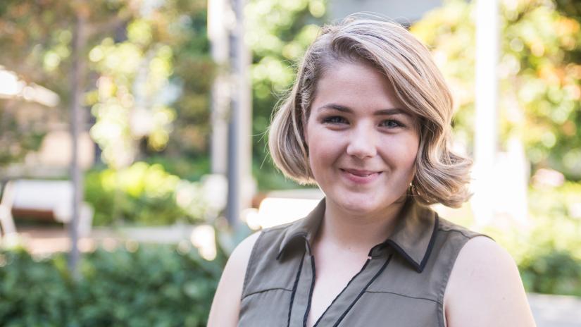 Rachel Bertram smiling at the camera on the Alumni Green