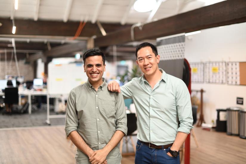 Mohammad Sakhvidi and Brad Chan smiling at the camera with Brad's arm resting on Mohammad's shoulder