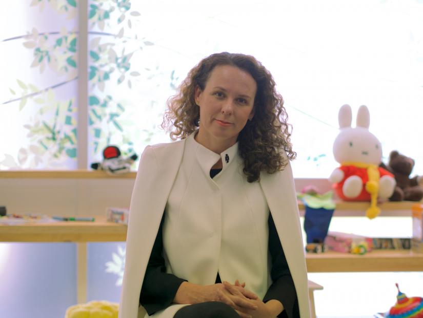 Dr Rachael Murrihy sitting on a chair, facing the camera in front of children's toys in the Kidman Centre