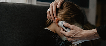 A mother checks a child's fever