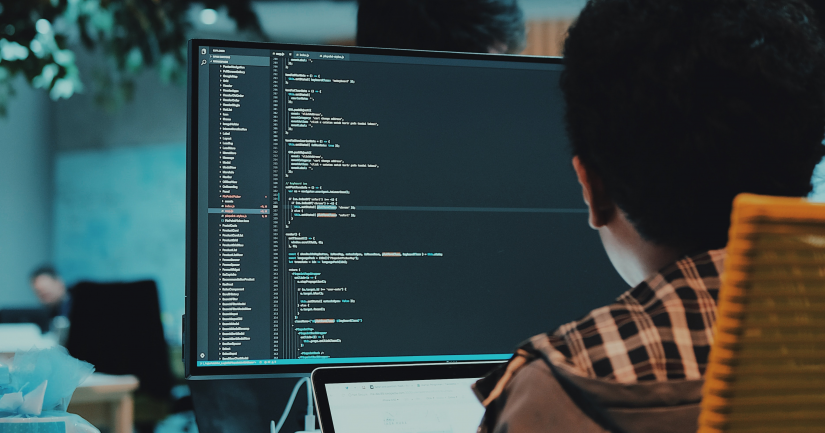 person coding on a computer