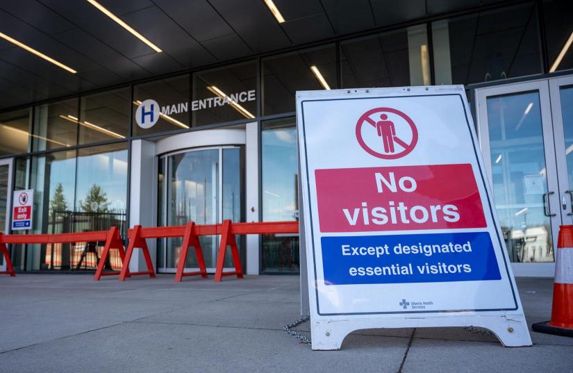 Hospital with no visitors sign due to COVID-19