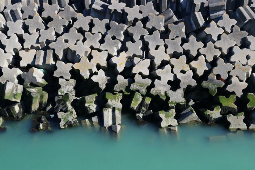 aerial view of cross-shaped concrete pillars and aqua green water