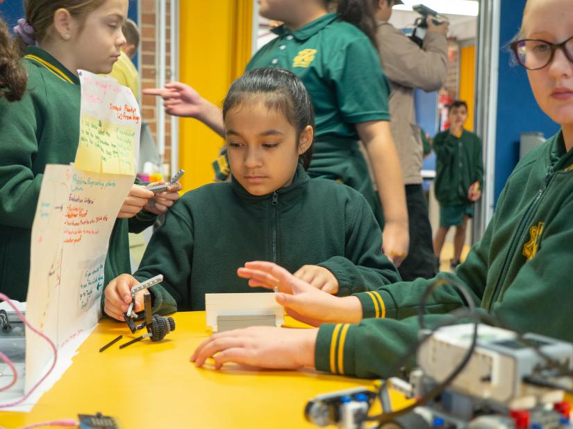 Girls playing with robots