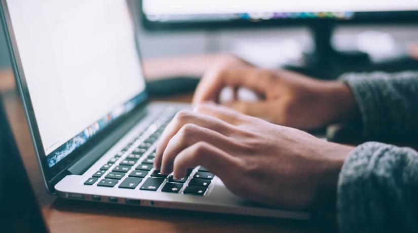 Person typing on laptop