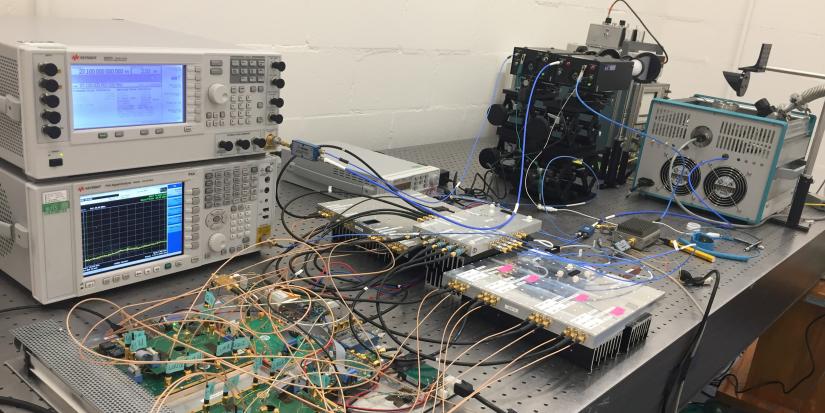 Machines and cabling set up on a table for the 20 Gbps THz transmission system prototype