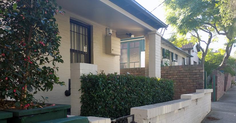 the exterior of a small suburban older house