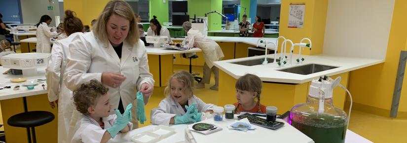 Scientist Alex Thomson shows kids her algae reactor.