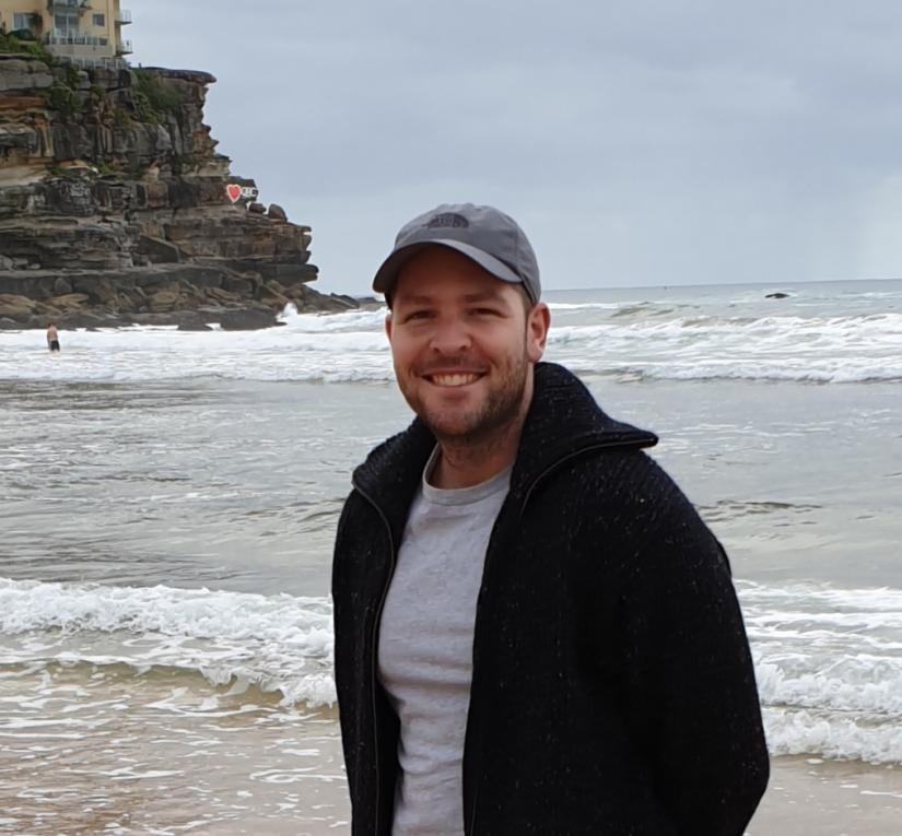 Young man wearing cap standing on beach