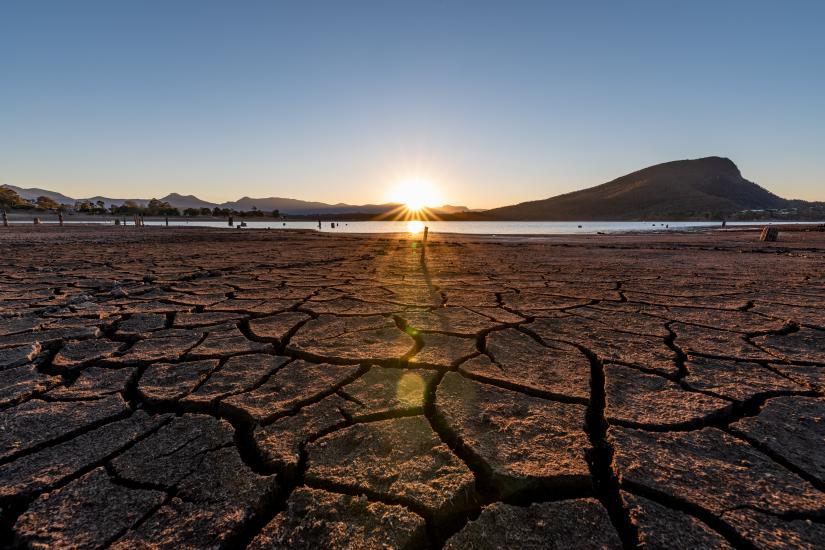 Dry ground with a low pond in the distance