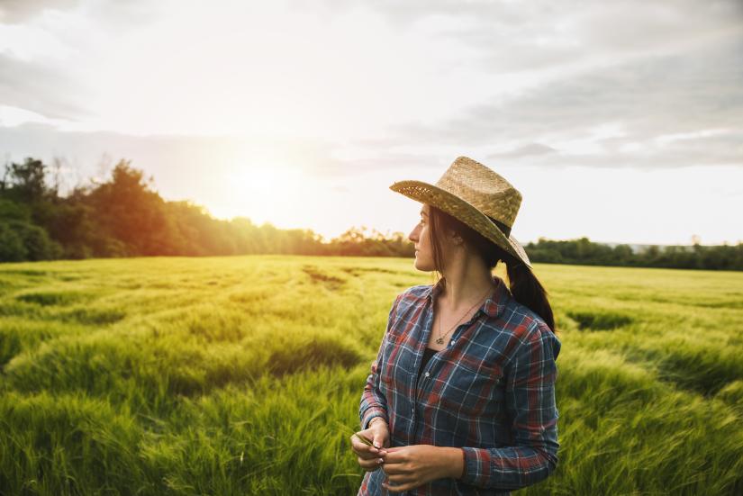 Woman farmer looking over field