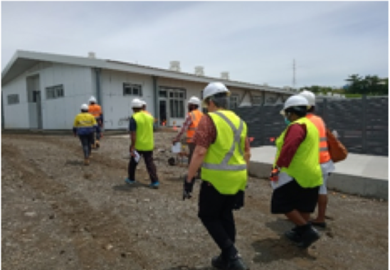Workers surveying property in high vision attire