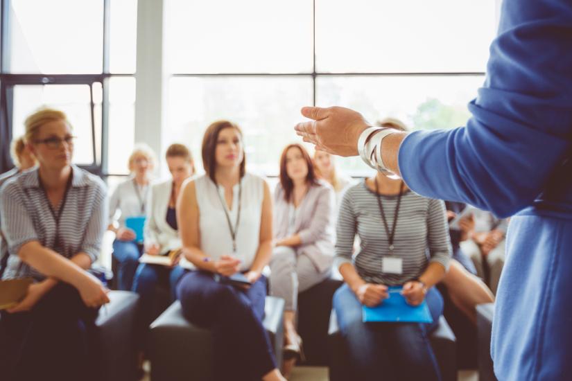 Group of people listening to a speaker