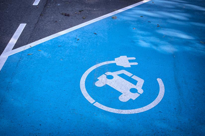 Electric vehicle charging symbol on road