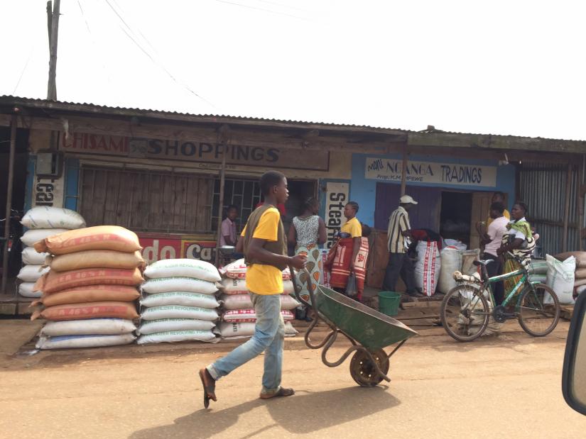 Fertiliser sale and man with wheelbarrow in Malawi
