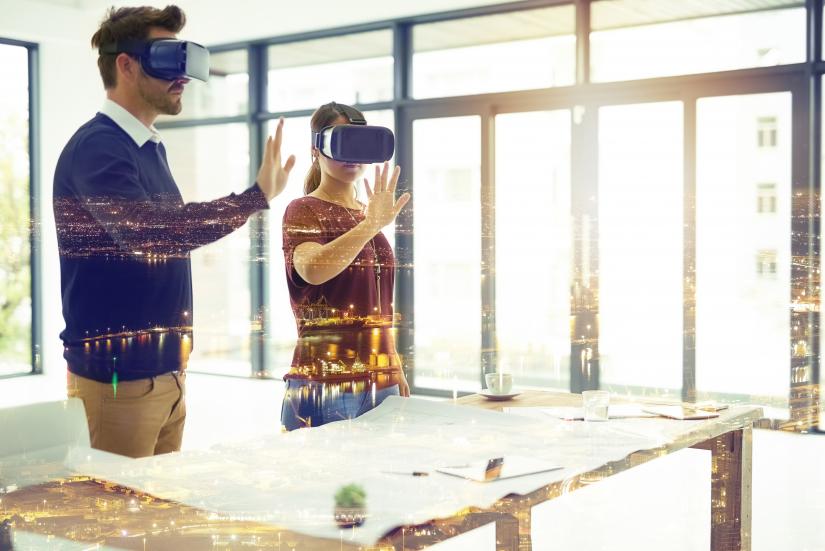 Two people wearing virtual reality goggles