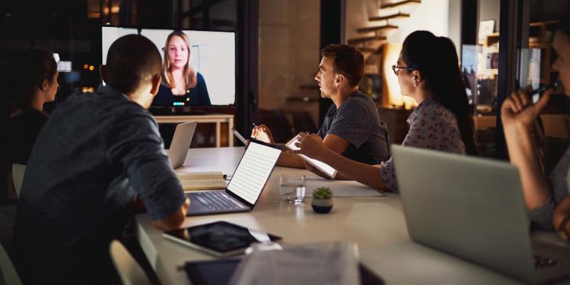 A group of students having a video conference call in the office