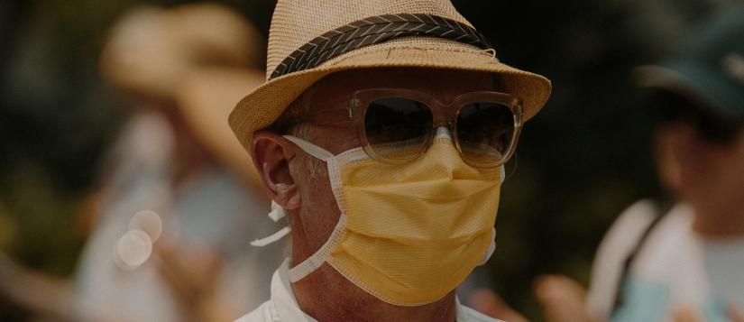 Man wearing mask and sun hat