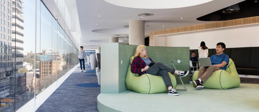 Students relaxing on green bean bags