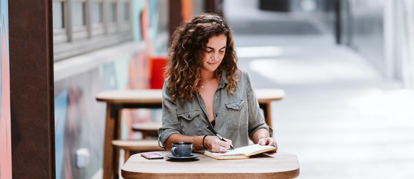 Student working at cafe table