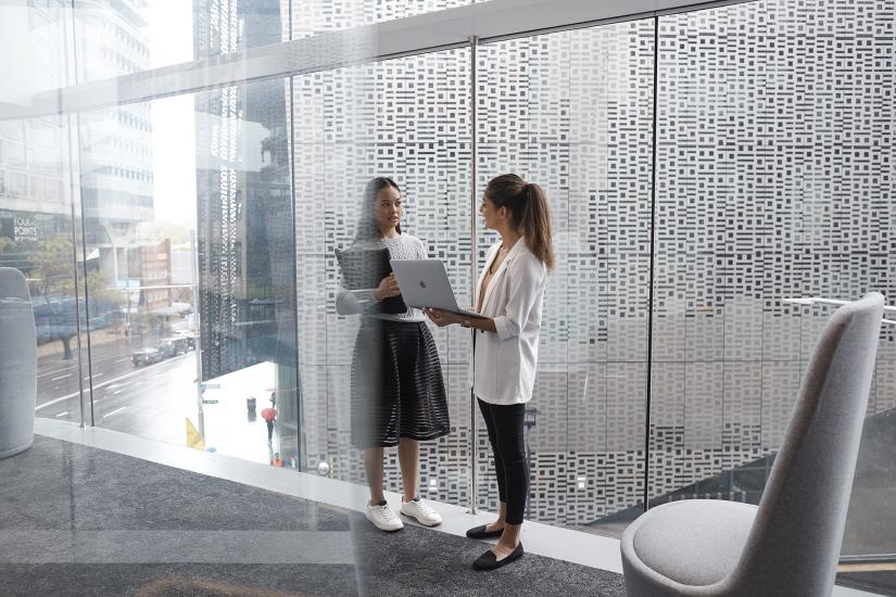 Two UTS female students socialising on campus inside building two