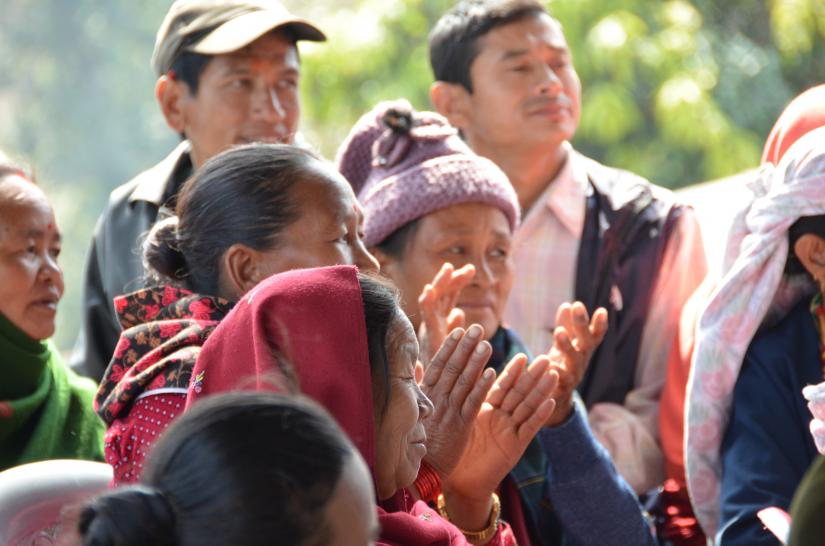 Nepalese men and women clapping