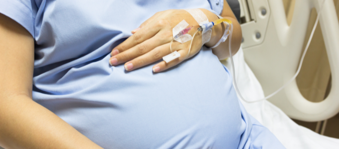 A pregnant woman in a hospital bed