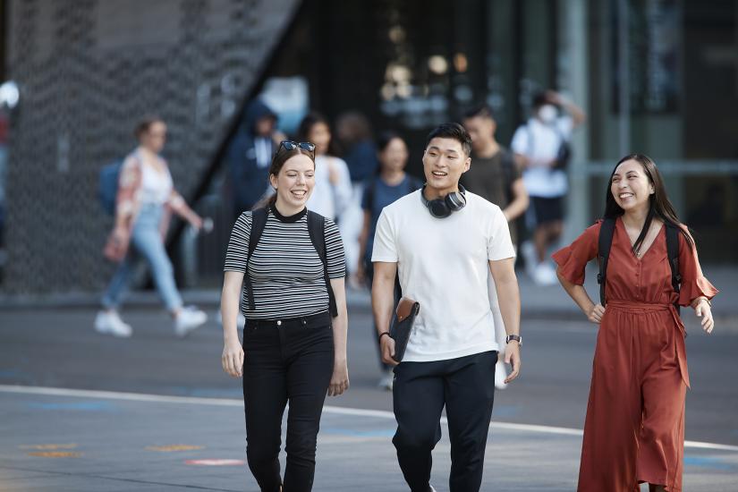 Group of students walking together outside UTS building eleven