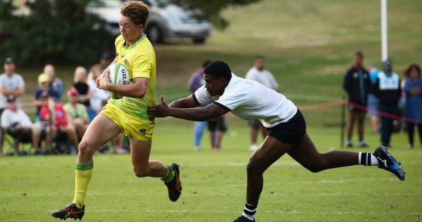 Jordan Williams running to avoid a tackle during a rugby match