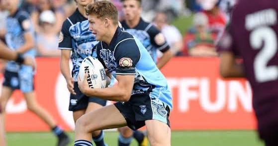 Louis Grossemy running withe ball during a rugby league game