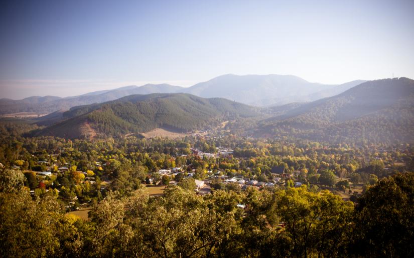 a remote town nestled amidst trees and mountains.