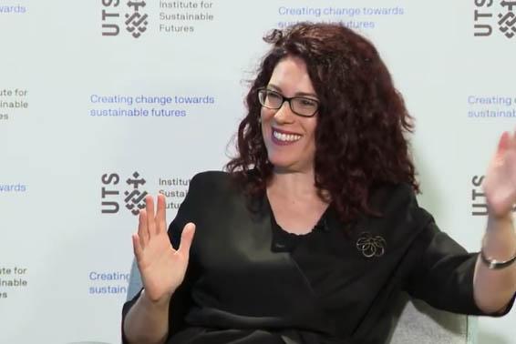 A woman is smiling and her arms are moving.