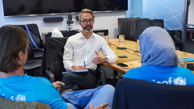 Oliver White, Unicef Australia Head of Governemnt Relations, speaks with two Unicef Australia Young Ambassadors 