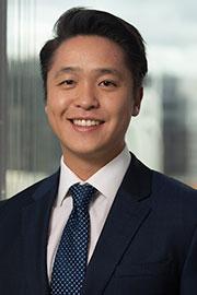 Man in a suit looking at the camera smiling
