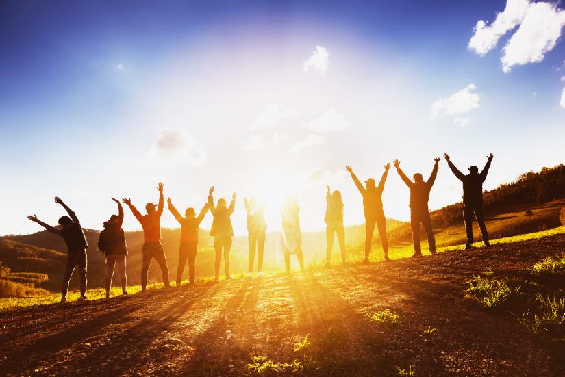 A group of people watching sunset