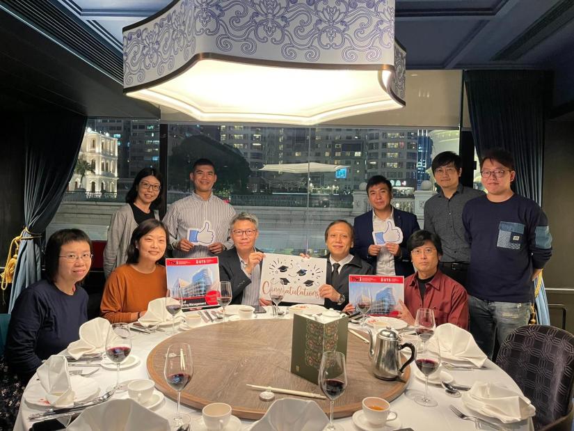 Graduates and academics sit around a table during THEi Graduation Dinner