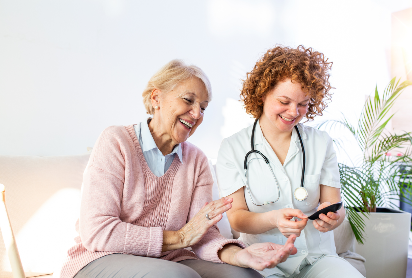 Nurse laughing with and supporting diabetes patient