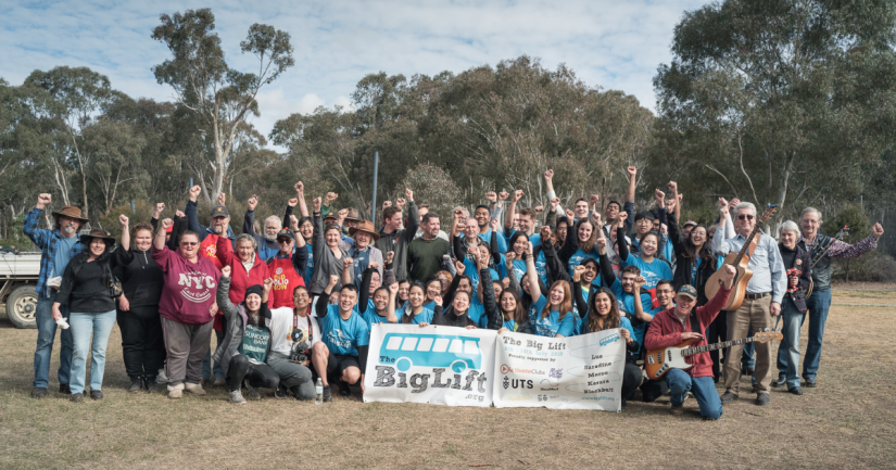 Group of students with their fists in the air on a volunteering trip with The Big Lift 