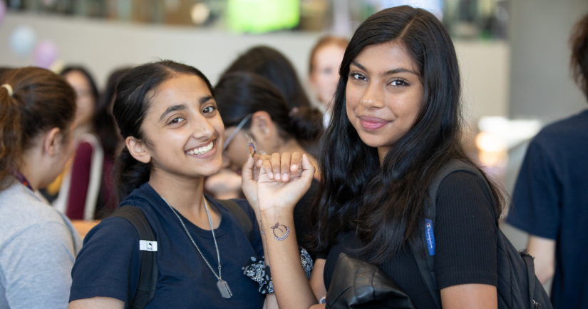 Two women on campus smiling