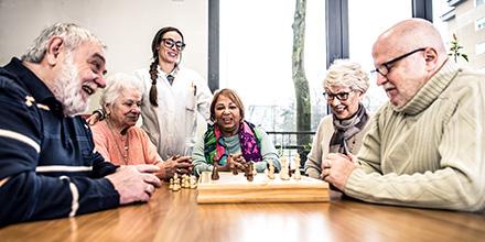 Group of elderly friends playing chess