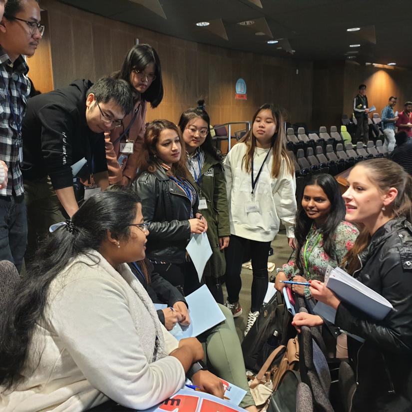 Group of students discussing in lecture hall