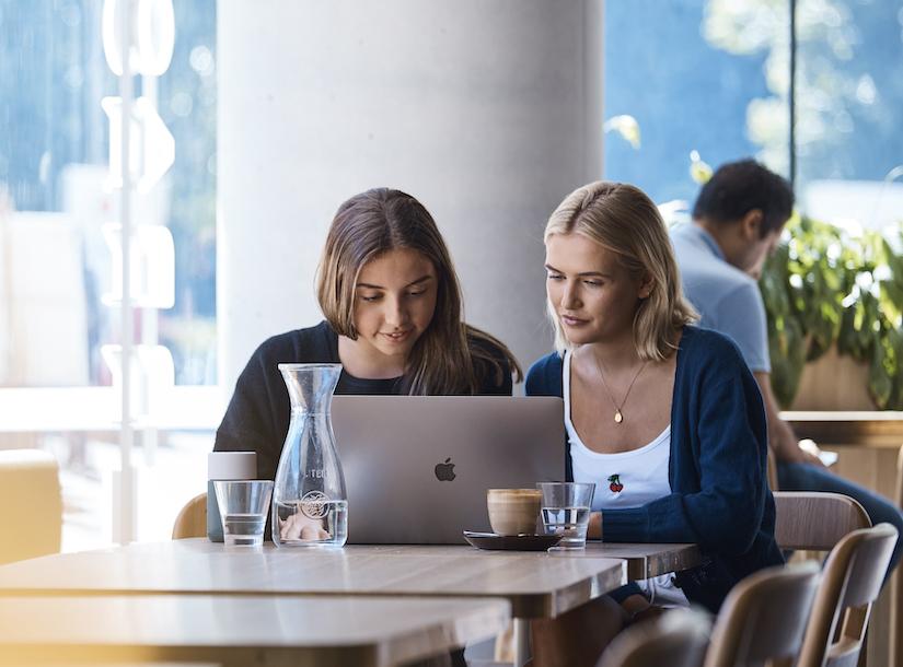 UTS Students in cafe looking at laptop