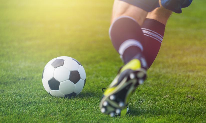 Running soccer player on grass