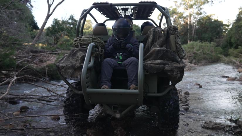 Intern on the back of a rough terrain vehicle