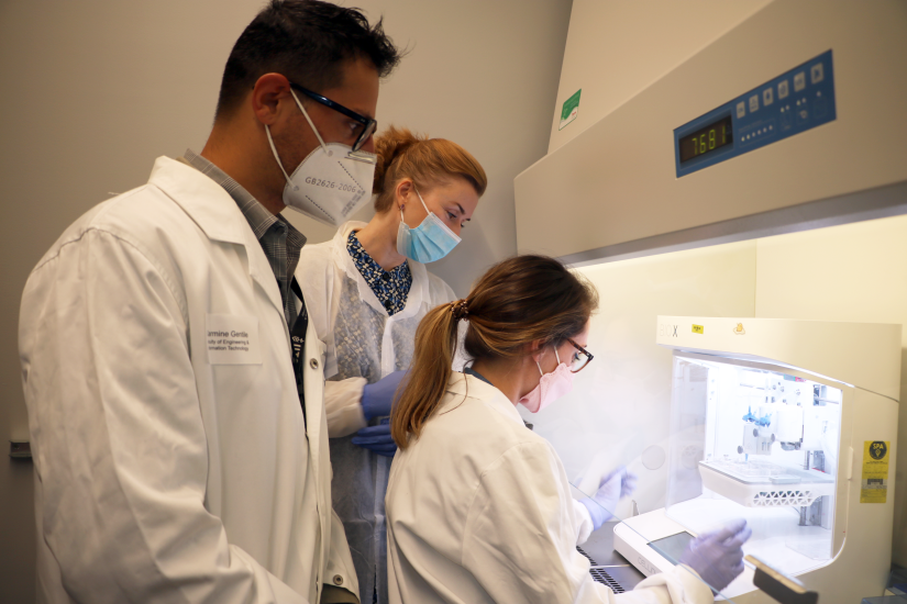 Photo of researchers using 3D bioprinter in UTS facility