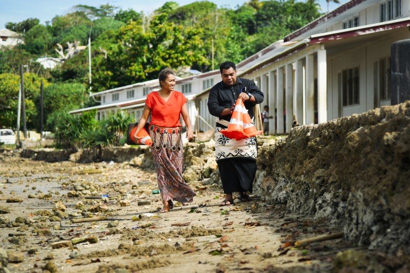 Image of two AVP workers walking along a road