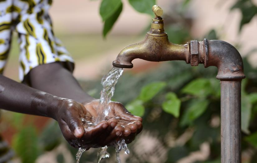 washing hands by tap