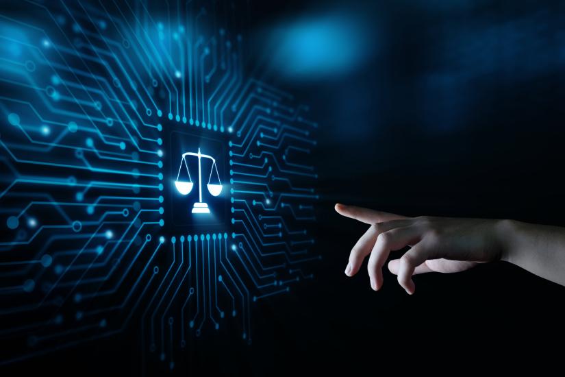 finger points at digital scales of justice
